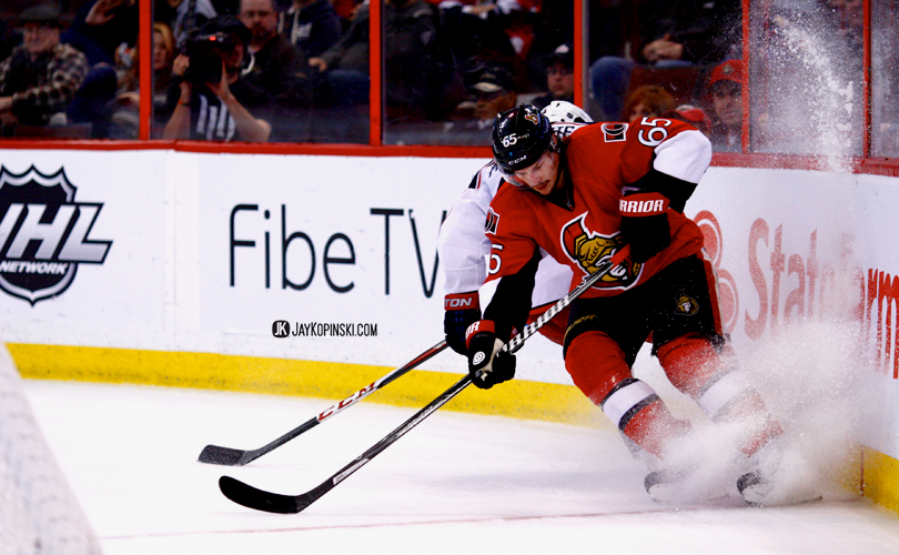 OTTAWA, CANADA - November 17: Ottawa Senators Defenceman Erik Karlsson (65) [6758] goes hard into the boards to stop the puck during a  game between the Blue Jackets and Senators at the Canadian Tire Centre on November 17, 2013 in Ottawa, Ontario, Canada. ***** Editorial Use Only ***** Jay Kopinski - Icon SMI