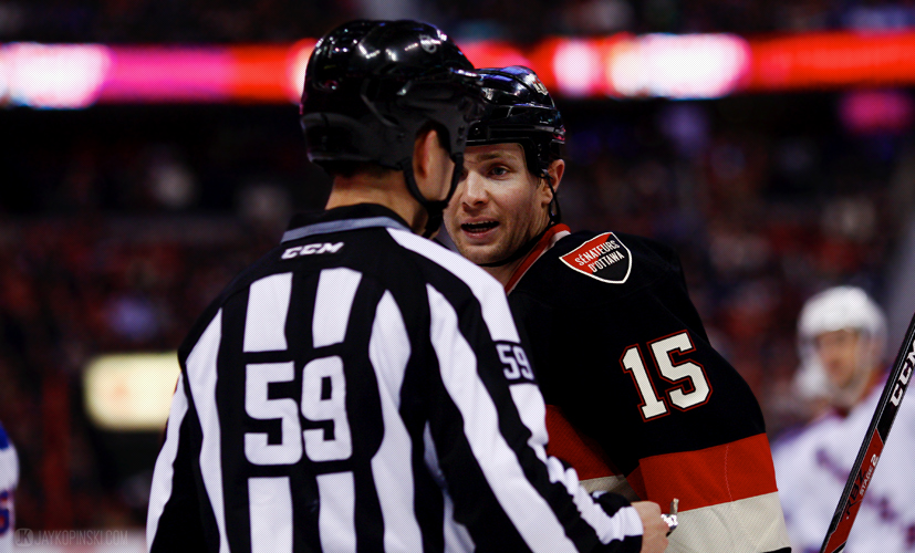 OTTAWA, CANADA - January 18:  Ottawa Senators Center Zack Smith (15) [6906] has a few words with Linesman Steve Barton (59)during a game between the Rangers and Senators at Canadian Tire Centre on January 18, 2014 in Ottawa, Ontario, Canada. ***** Editorial Use Only *****Jay Kopinski - Icon/SMI