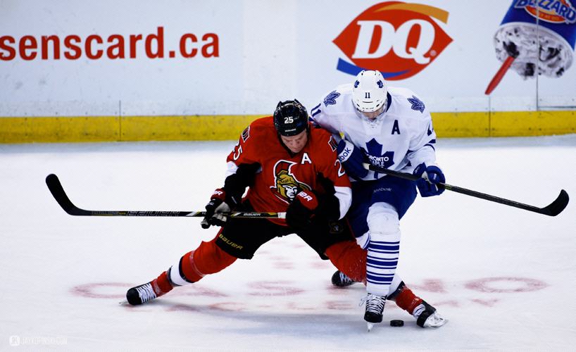 OTTAWA, CANADA - April 12:  Ottawa Senators Right Wing Chris Neil (25) [1585] and Toronto Maple Leafs Center Jay McClement (11) [2518] get tangled up during a game between the Maple Leafs and Senators at Canadian Tire Centre on April 12, 2014 in Ottawa, Ontario, Canada. ***** Editorial Use Only ***** Jay Kopinski - Icon/SMI