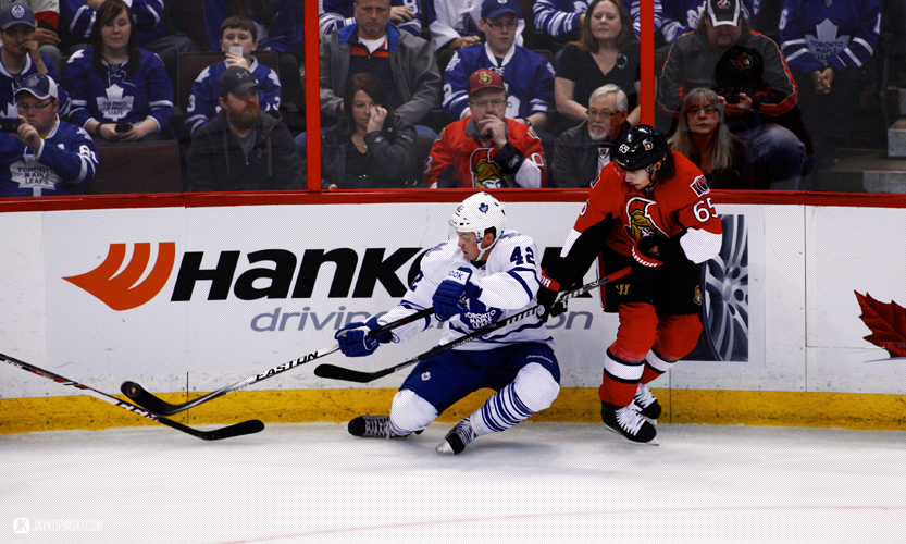 OTTAWA, CANADA - April 12:  Toronto Maple Leafs Center Tyler Bozak (42) [7017] plays the puck falling down after being bumped  by Ottawa Senators Defenceman Erik Karlsson (65) [6758] during a game between the Maple Leafs and Senators at Canadian Tire Centre on April 12, 2014 in Ottawa, Ontario, Canada. ***** Editorial Use Only ***** Jay Kopinski - Icon/SMI