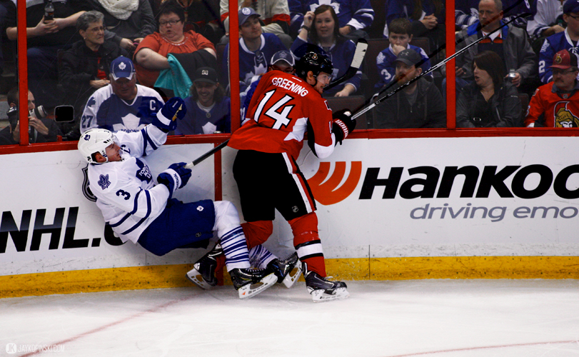 OTTAWA, CANADA - April 12:  Ottawa Senators Left Wing Colin Greening (14) [5216] with a hit on Toronto Maple Leafs Defenceman Dion Phaneuf (3) [3507] during a game between the Maple Leafs and Senators at Canadian Tire Centre on April 12, 2014 in Ottawa, Ontario, Canada. ***** Editorial Use Only ***** Jay Kopinski - Icon/SMI